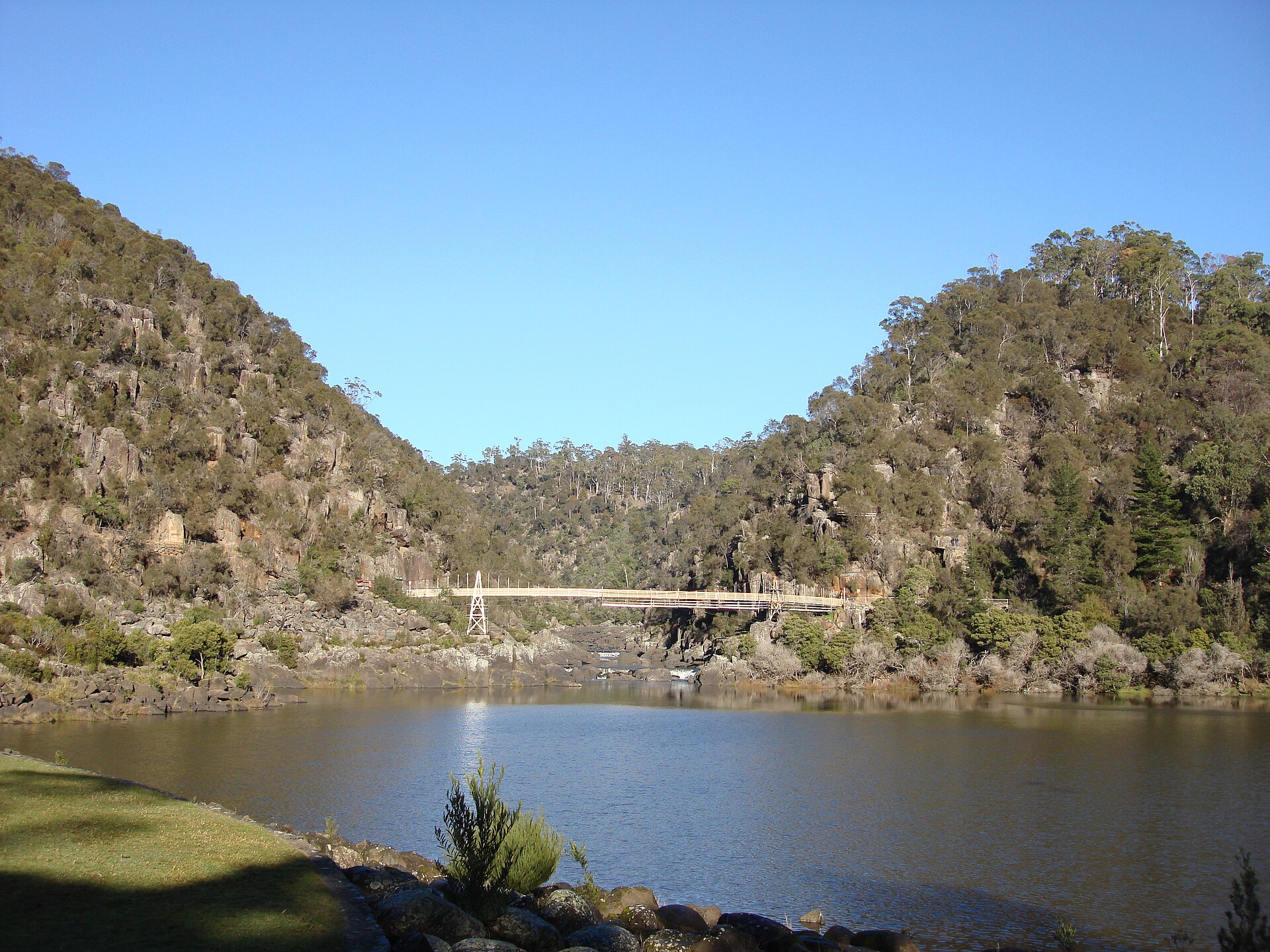 The Cataract Gorge is a river gorge in northern Tasmania, near Launceston, and is one of the region's premier tourist attractions. A pathway, known as the King’s Bridge-Cataract Walk, and originally built by volunteers in the 1890s, runs along the north bank of the Cataract Gorge, and is a popular tourist destination. The chairlift crossing the Gorge is the longest single span chairlift in the world, with the longest span being 308m (924 ft). The chairlift, built in 1972, has a total span of 457m. Before the Hydro Dam was built in the 1950's upstream, flood waters could rise up as high as 12 metres. In the past, there was a power station at Duck Reach, about 2.5 kilometres from the suspension bridge. It was washed away in the floods of 1929, rebuilt and then decommissioned when the new Hydro Dam was finished in 1955. The building is now an interpretive museum. The First Basin on the southern side features a swimming pool and an open area surrounded by bushland. At the lower end of the Gorge, the South Esk spills into the Tamar River going under Kings Bridge on the way. This was the only bridge leading north out of the city for nearly 100 years. [Wikipedia.org]