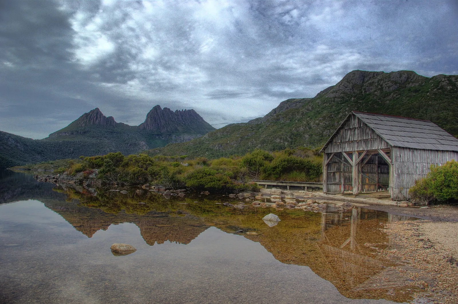 Classic view of Cradle Mountain over Dove Lake, with old boat shed in foreground. HDR from 5 photos, combined using PhotomatixPro. Retouched in Picasa (specks on sensor).