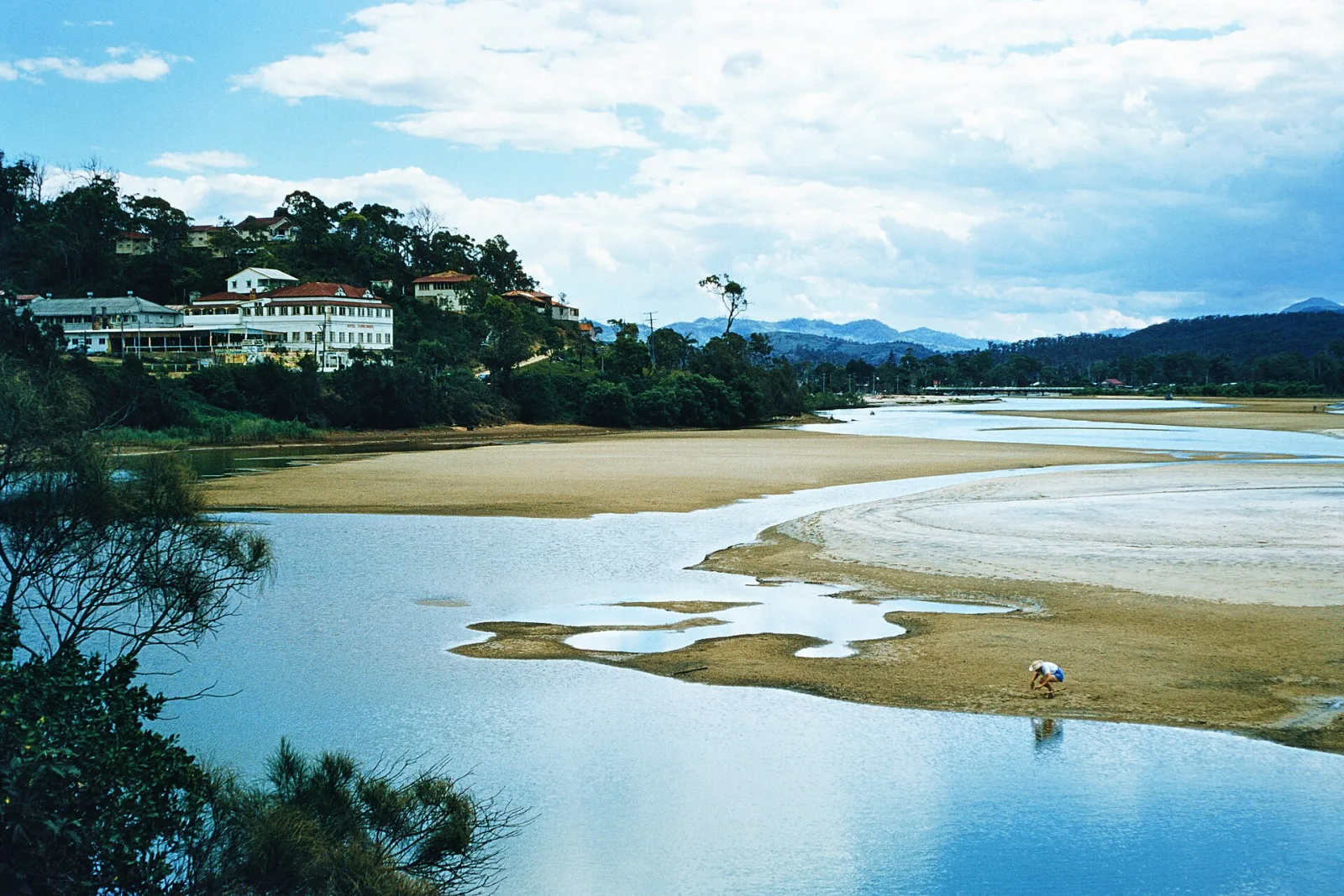 The first hotel was built by Wallace McDonald Nicoll in 1910 on Duringan Street overlooking the mouth of the Currumbin Creek. Currumbin Hotel was demolished in 1996 and replaced with modern apartments. Tourism and industry significantly increased through the 20th century. Currumbin Creek starts its journey to the sea through the gorges of Mt Cougal National Park before gathering at the Currumbin Rock Pools, a popular swimming and picnic spot for tourists and locals. The 20 kilometre long creek then travels through agricultural and residential land before reaching the Pacific Ocean just north of Currumbin and Elephant Rocks. In an attempt to stabilise the mouth of the creek a seawall from Currumbin Rock to the mouth of the river was built in 1973 and 1978 with a rock wall also constructed on the northern side of the creek at southern Palm Beach in 1981. The area in front of the creek mouth, known as Currumbin Alley, is a popular local surf break and is part of the Gold Coast World Surfing Reserve. (https://www.goldcoaststories.com.au/currumbin-creek/) The Currumbin Creek rises in the Gold Coast hinterland below Mount Cougal in the Springbrook National Park, west of the New South Wales settlement of Tomewin and north of the New South Wales/Queensland border. The creek flows generally north by east through the Currumbin Valley towards Currumbin where it is crossed by the Pacific Motorway and the Gold Coast Highway, before reaching its mouth at Currumbin Alley and emptying into the Coral Sea. The creek descends 138 metres (453 ft) over its 24-kilometre (15 mi) course (Wikipedia)