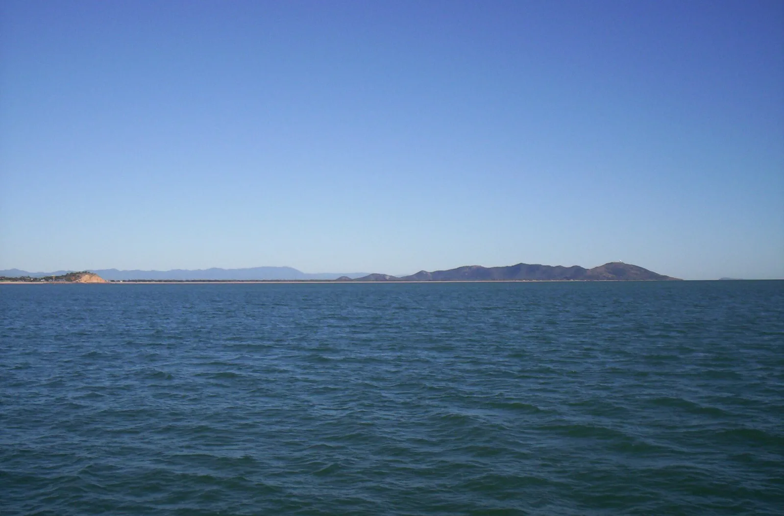 Magnetic Island is an island 8 kilometres (5 mi) offshore from the city of Townsville]], Queensland, Australia. This 52 km2 (20.1 sq mi) mountainous island in Cleveland Bay has effectively become a suburb of Townsville, with 2,335 permanent residents.