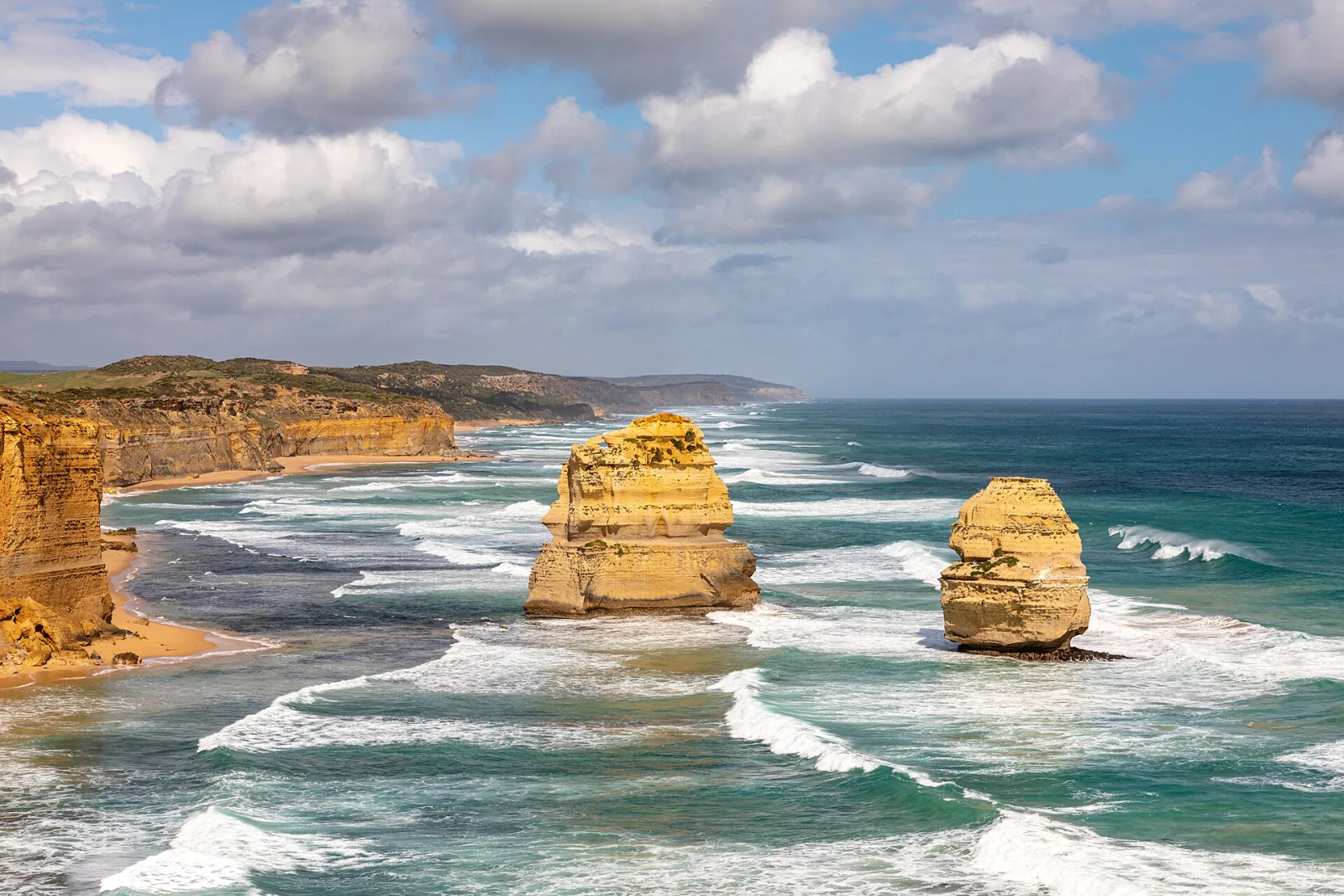 Twelve Apostles at Port Campbell National Park, Princetown, Victoria, AustraliaPort Campbell National Park is located on the south coast of Victoria along the Great Ocean Road and protects a spectacular coastal landscape of limestone, cliffs, caves, and natural bridges.Its geological formation dates back millions of years: over thousands of years, layers of limestone and shells formed caves, gateways, and towers, which were repeatedly eroded by the Southern Ocean. The coast also served as a habitat for indigenous groups in the region, including the Wergaia and Eastern Maar communities. From the 1950s/60s onwards, the area was designated a protected area to preserve its exceptional geology, wildlife, and flora and to manage visitor flows in a sensible manner.Special features include the famous limestone cliffs, narrow passages, natural bridges, and steep cliffs; highlights such as the Twelve Apostles, Loch Ard Gorge, and other coastal formations attract many visitors each year. The sea is home to seals, seabirds, and rich marine fauna, while the rocky shores also support maritime flora. Hiking trails, lookout points, and boat tours offer insights into geology, geomorphology, and coastal protection—a harmonious combination of natural wonders and historical perspective.